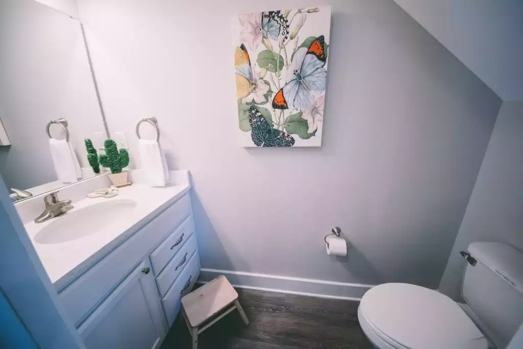 Powder room tucked under the main stairs